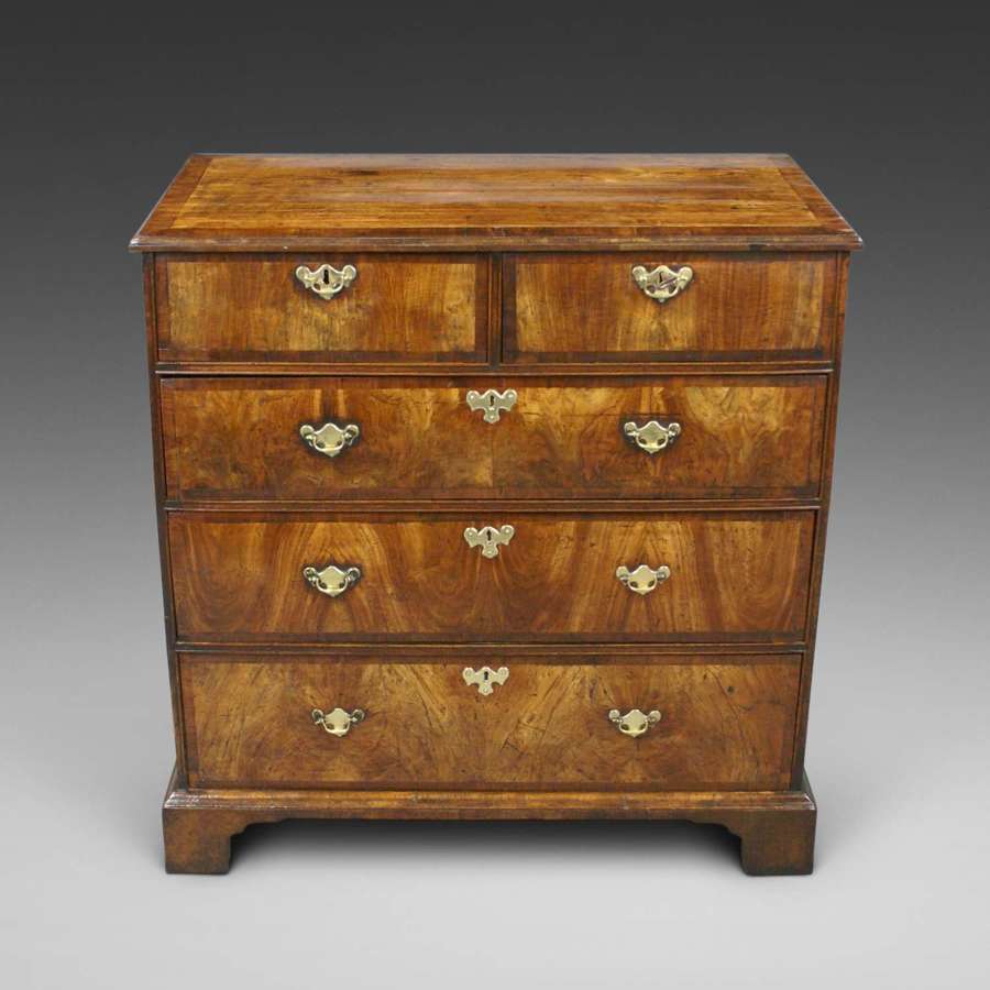 An early 18th Century walnut five drawer chest