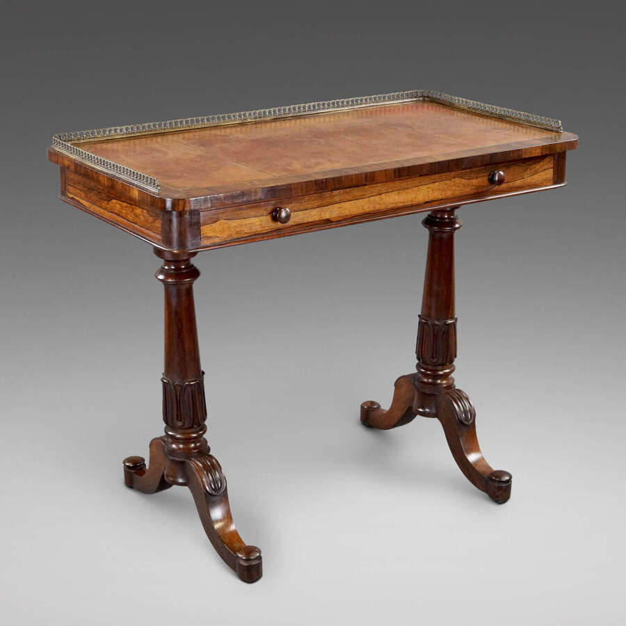 A mid- 19th century rosewood writing table