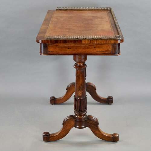 A mid- 19th century rosewood writing table