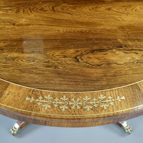 A Regency period rosewood and brass inlaid breakfast table